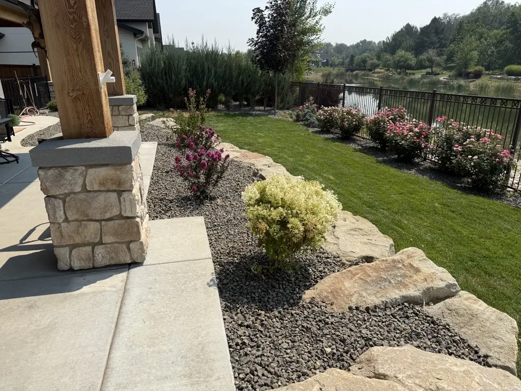 Finished rock landscaping beds with shrubs - Star Idaho