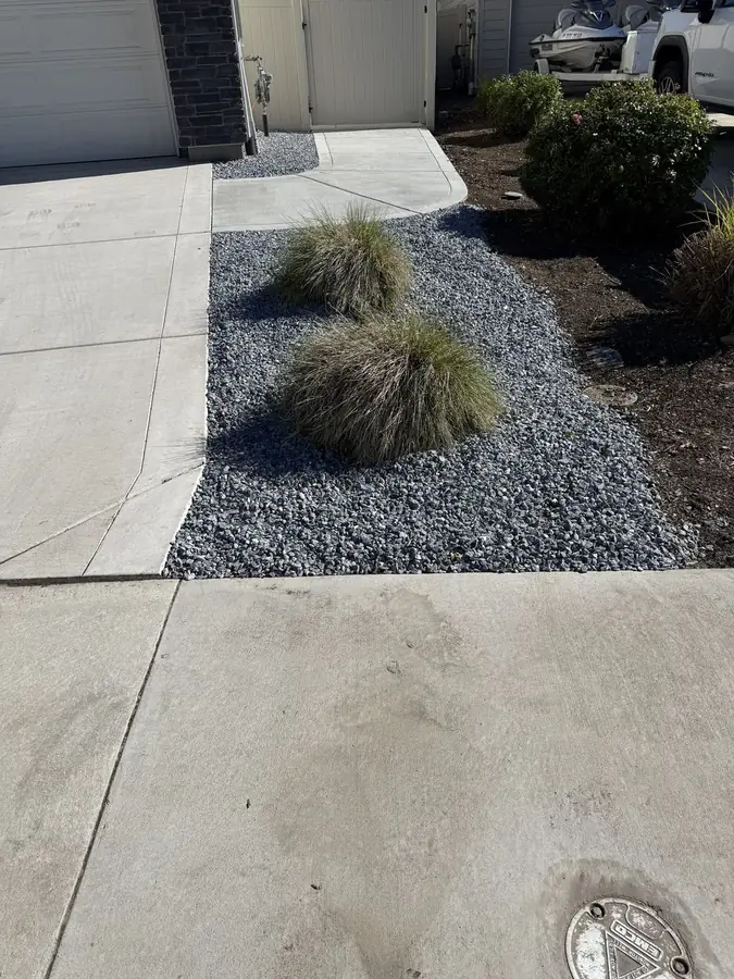 Finished front yard gravel beds with ornamental shrubs
